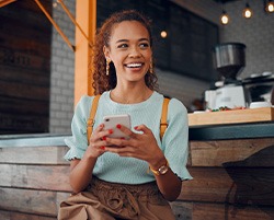 Smiling woman sitting on barstool at restaurant