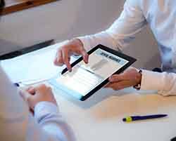 Dentist reviewing dental insurance form with patient