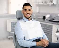 Patient smiling while sitting in dentist's treatment chair